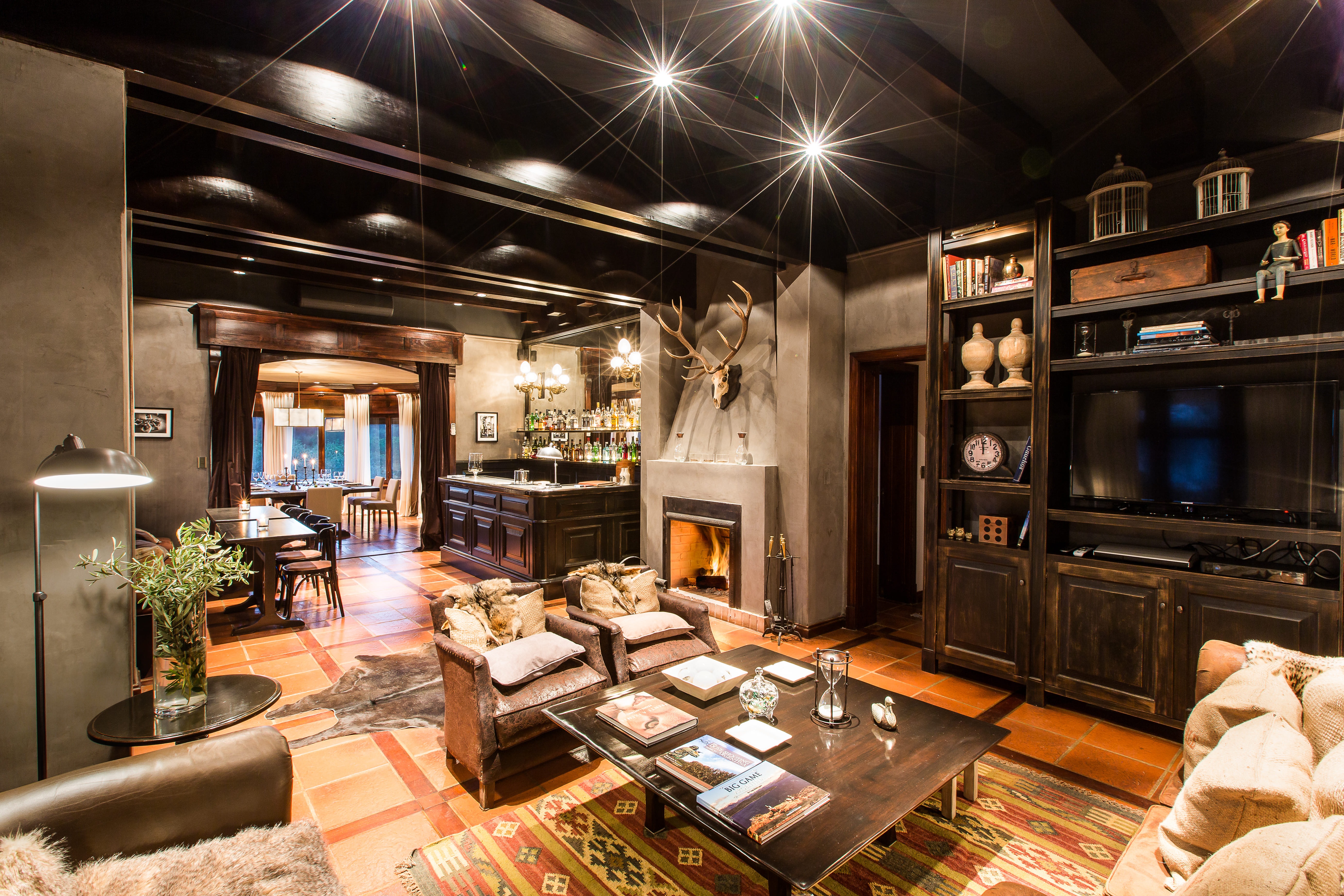 Rustic-luxury living room with stone fireplace and bar